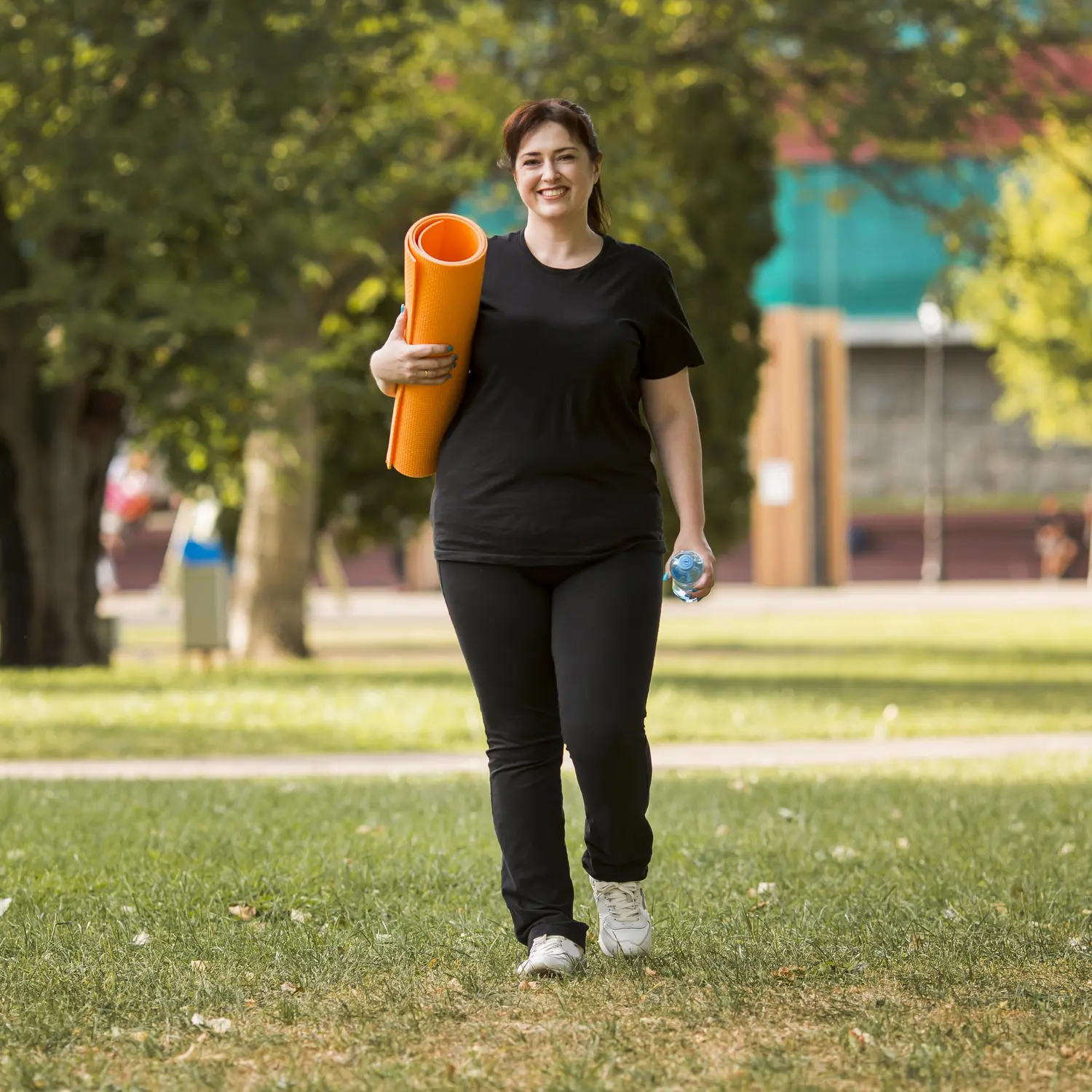 woman sportswear holding yoga mat